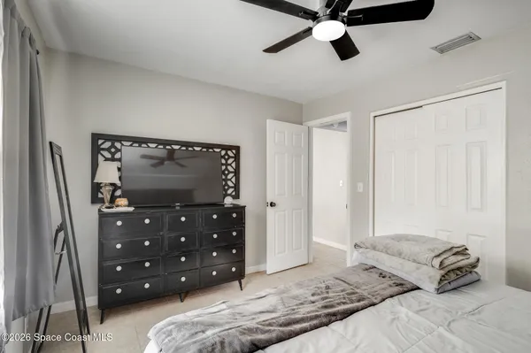 a bedroom with a bed and a tv