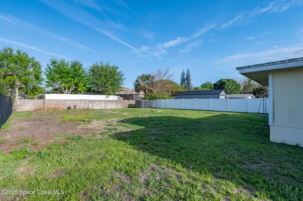 a view of yard with swimming pool and green space