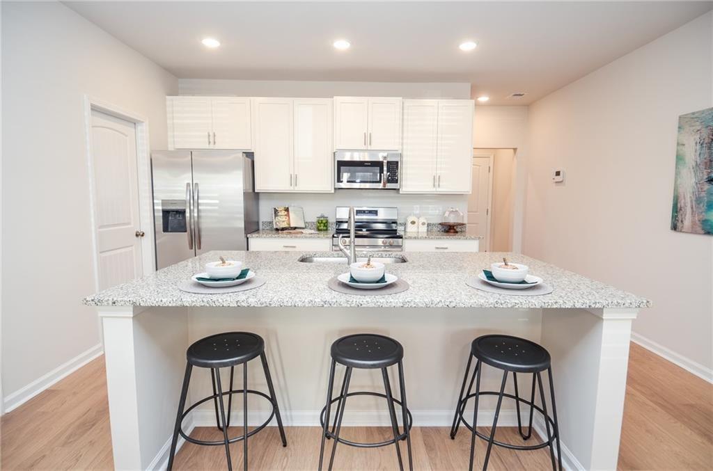4551 High Rdg Court Sugar Hill, GA 30518 - Photo 12 of 40 a kitchen with stainless steel appliances granite countertop a sink and cabinets