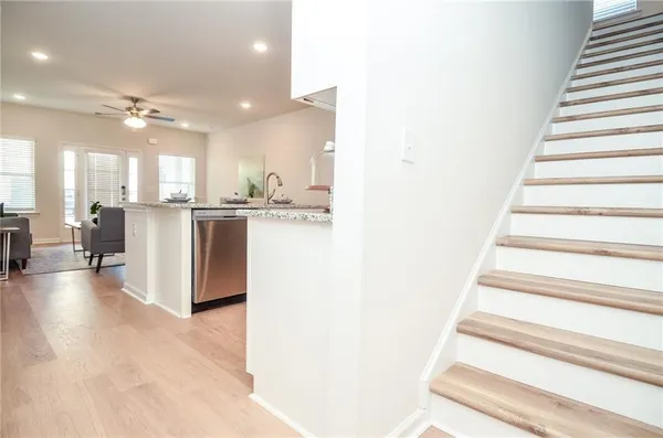 a large kitchen with kitchen island a sink a stove a dining table and chairs