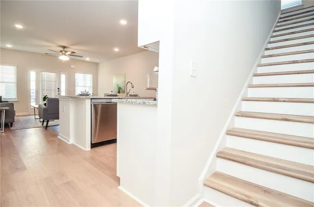 a large kitchen with kitchen island a sink a stove a dining table and chairs