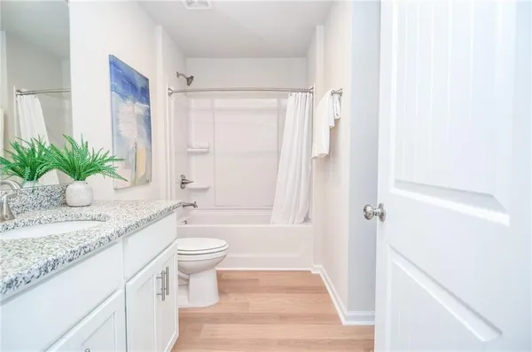 a bathroom with a toilet and a bathtub