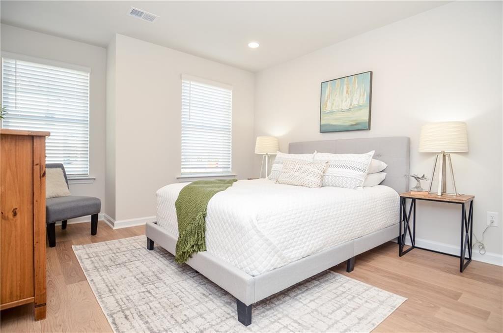 4551 High Rdg Court Sugar Hill, GA 30518 - Photo 23 of 40 a bedroom with a bed and a lamp