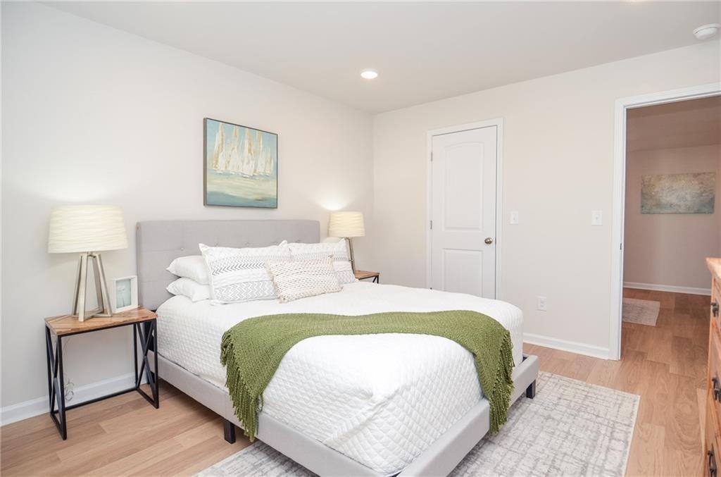 4551 High Rdg Court Sugar Hill, GA 30518 - Photo 24 of 40 a bedroom with a bed and a night stand