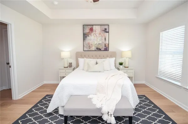 a bedroom with a bed and a painting on the wall