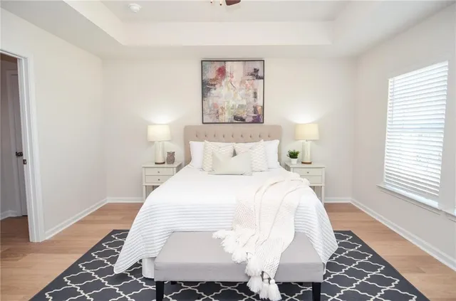 a bedroom with a bed and a painting on the wall