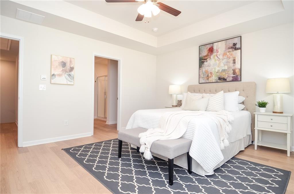 4551 High Rdg Court Sugar Hill, GA 30518 - Photo 31 of 40 a bedroom with a bed and a painting on the wall