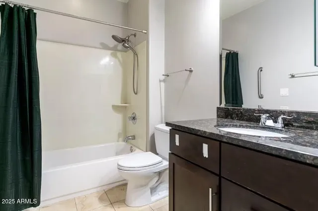 a bathroom with a granite countertop sink toilet mirror and shower