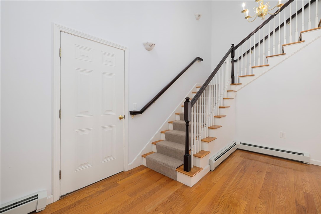 9 Spring Street Jamestown, RI 02835 - Photo 23 of 47 Stairs leading to the second floor and door leading to garage and basement