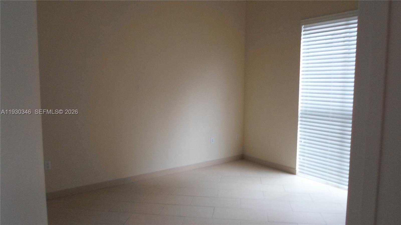 7275 Southwest 90th Way, Unit G 611 Miami, FL 33156 - Photo 6 of 56 a view of an empty room with a window