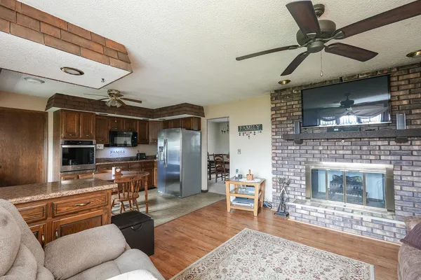 a bathroom with a granite countertop sink toilet a large mirror and shower