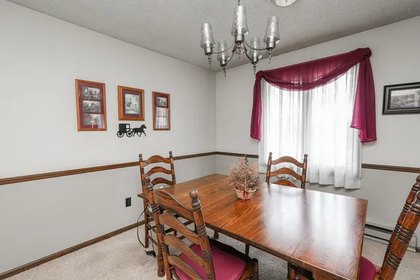 a living room with furniture a fireplace and a ceiling fan
