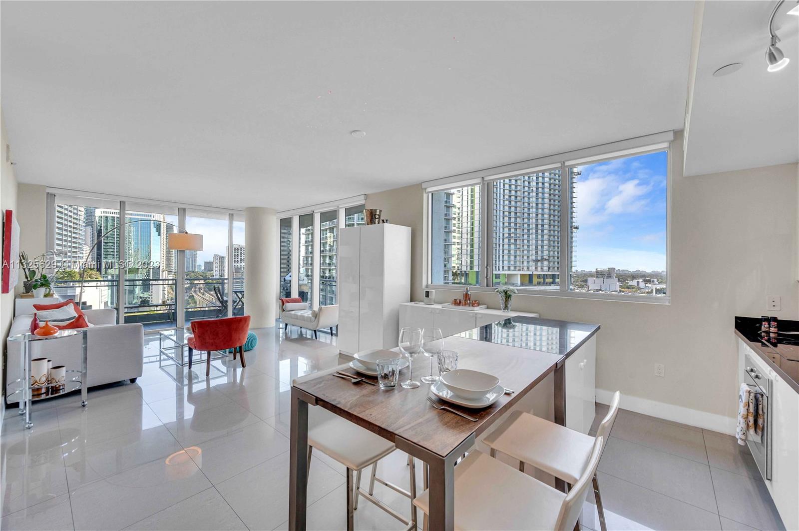 92 Southwest 3rd Street, Unit 1605 Miami, FL 33130 - Photo 11 of 37 a dining room with a table and chairs