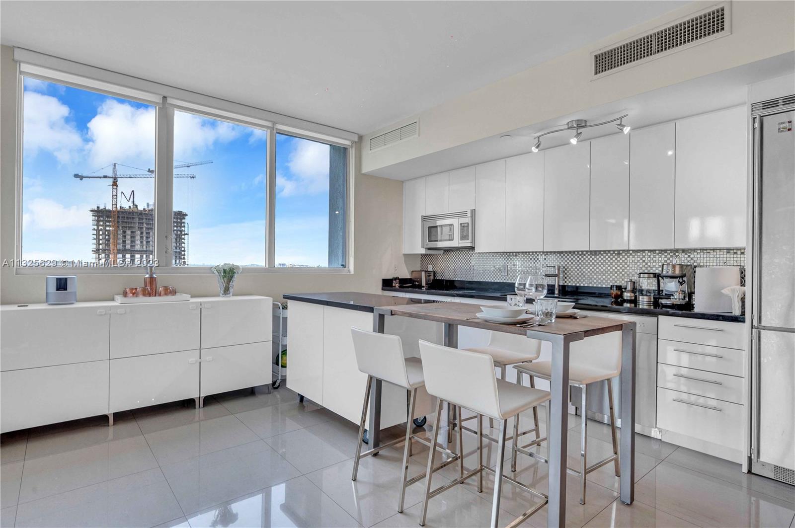 92 Southwest 3rd Street, Unit 1605 Miami, FL 33130 - Photo 12 of 37 a kitchen with cabinets a sink and appliances