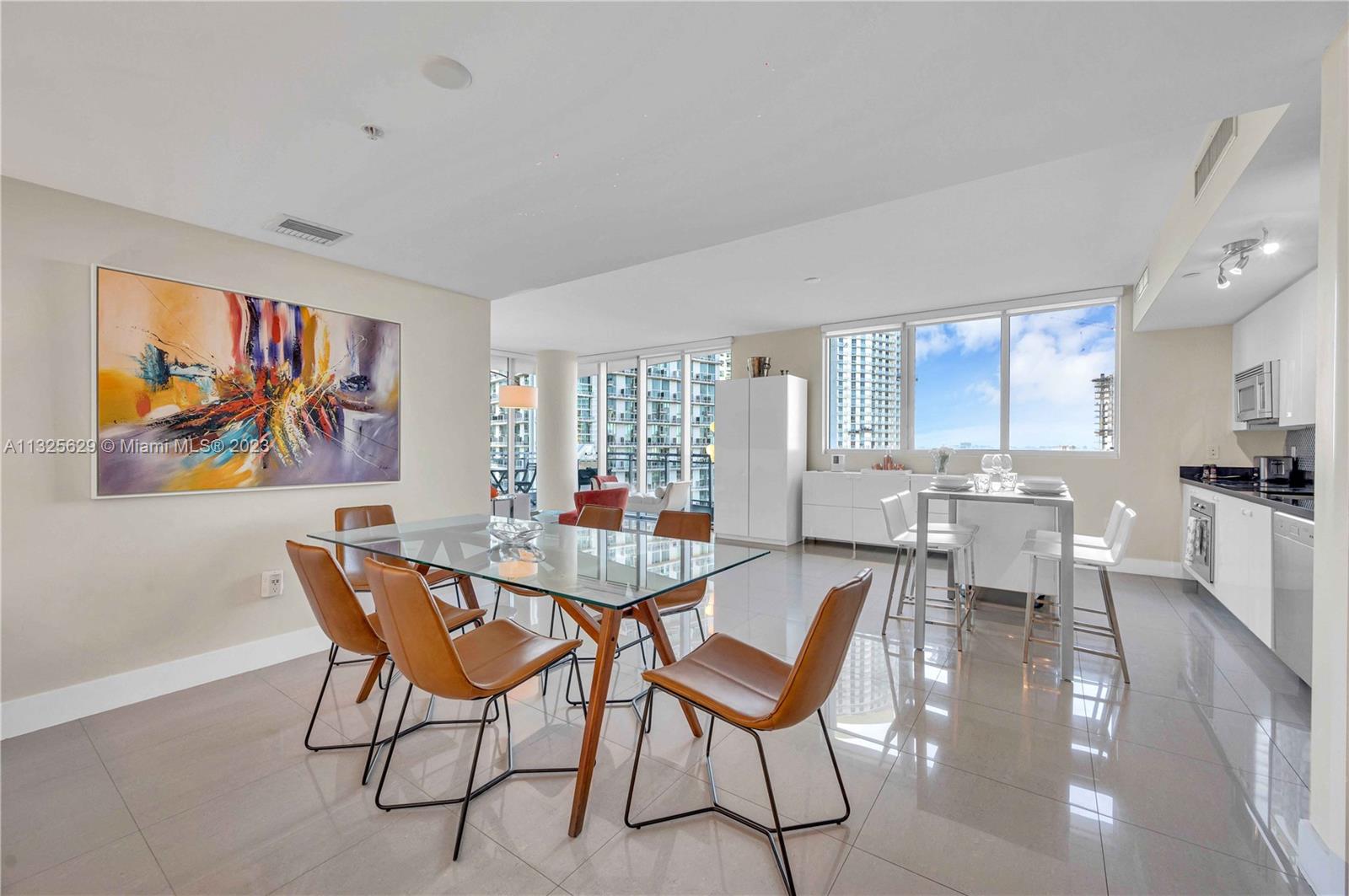92 Southwest 3rd Street, Unit 1605 Miami, FL 33130 - Photo 15 of 37 a view of a dining room with furniture a rug and wooden floor