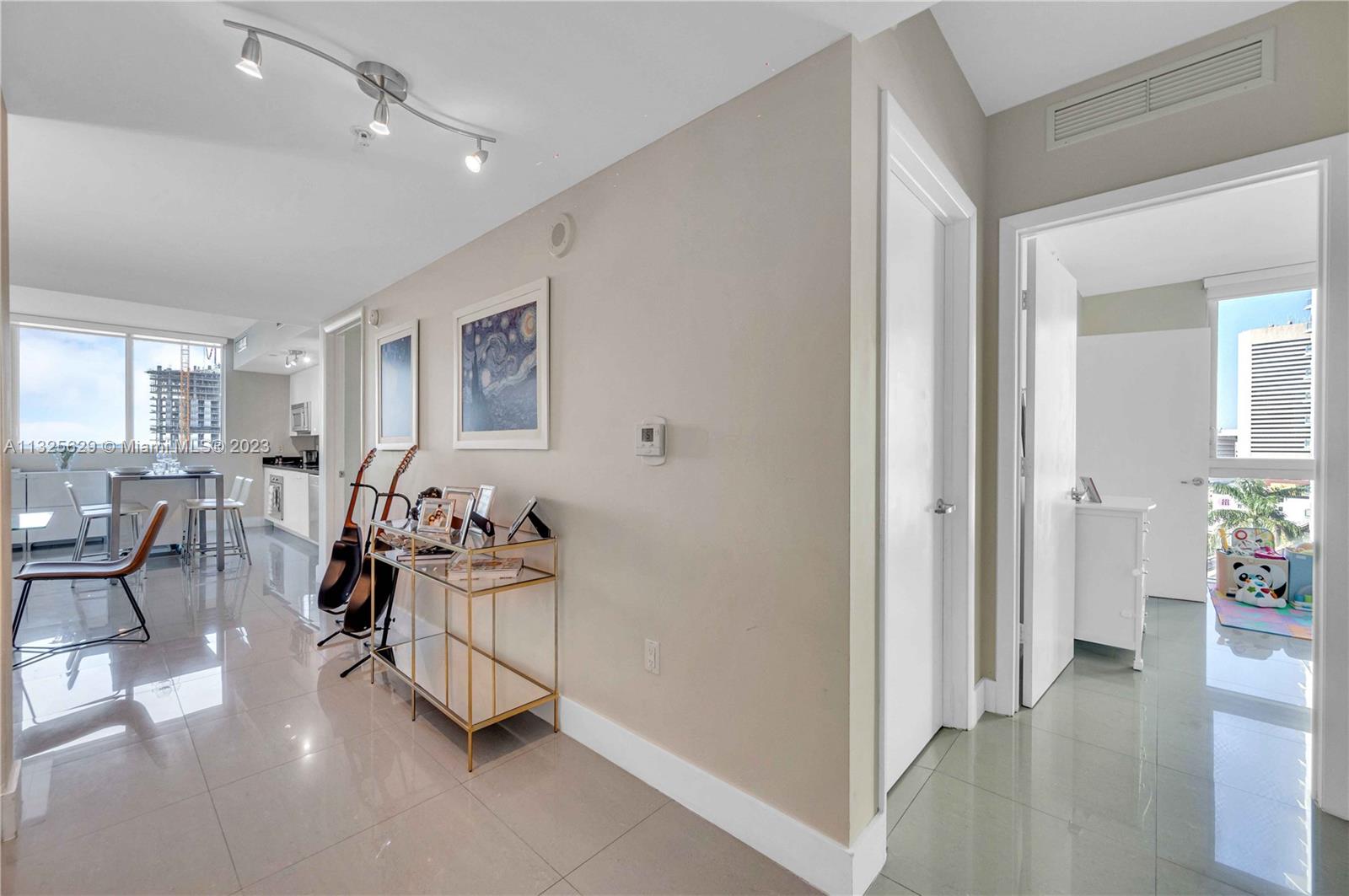 92 Southwest 3rd Street, Unit 1605 Miami, FL 33130 - Photo 18 of 37 a living room with furniture and wooden floor