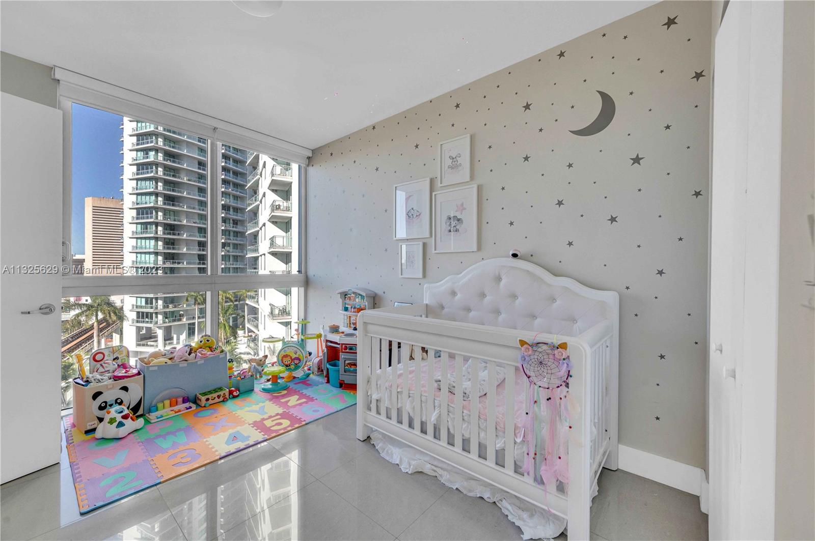 92 Southwest 3rd Street, Unit 1605 Miami, FL 33130 - Photo 19 of 37 a bedroom with furniture a baby crib and a window