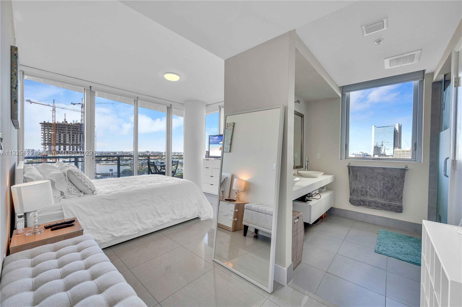92 Southwest 3rd Street, Unit 1605 Miami, FL 33130 - Photo 22 of 37 a living room with furniture and a large mirror