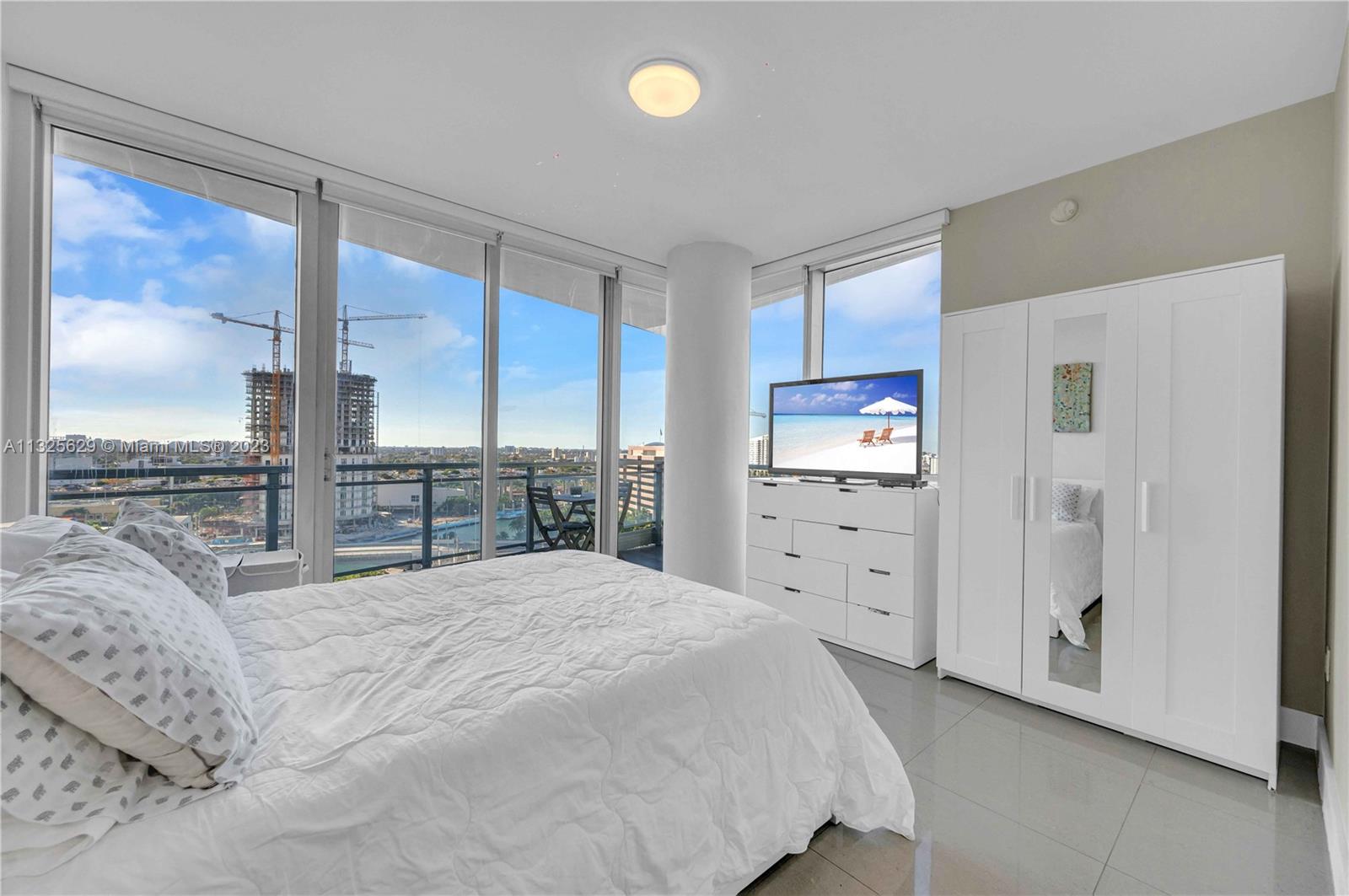 92 Southwest 3rd Street, Unit 1605 Miami, FL 33130 - Photo 23 of 37 a large white bed in a white room