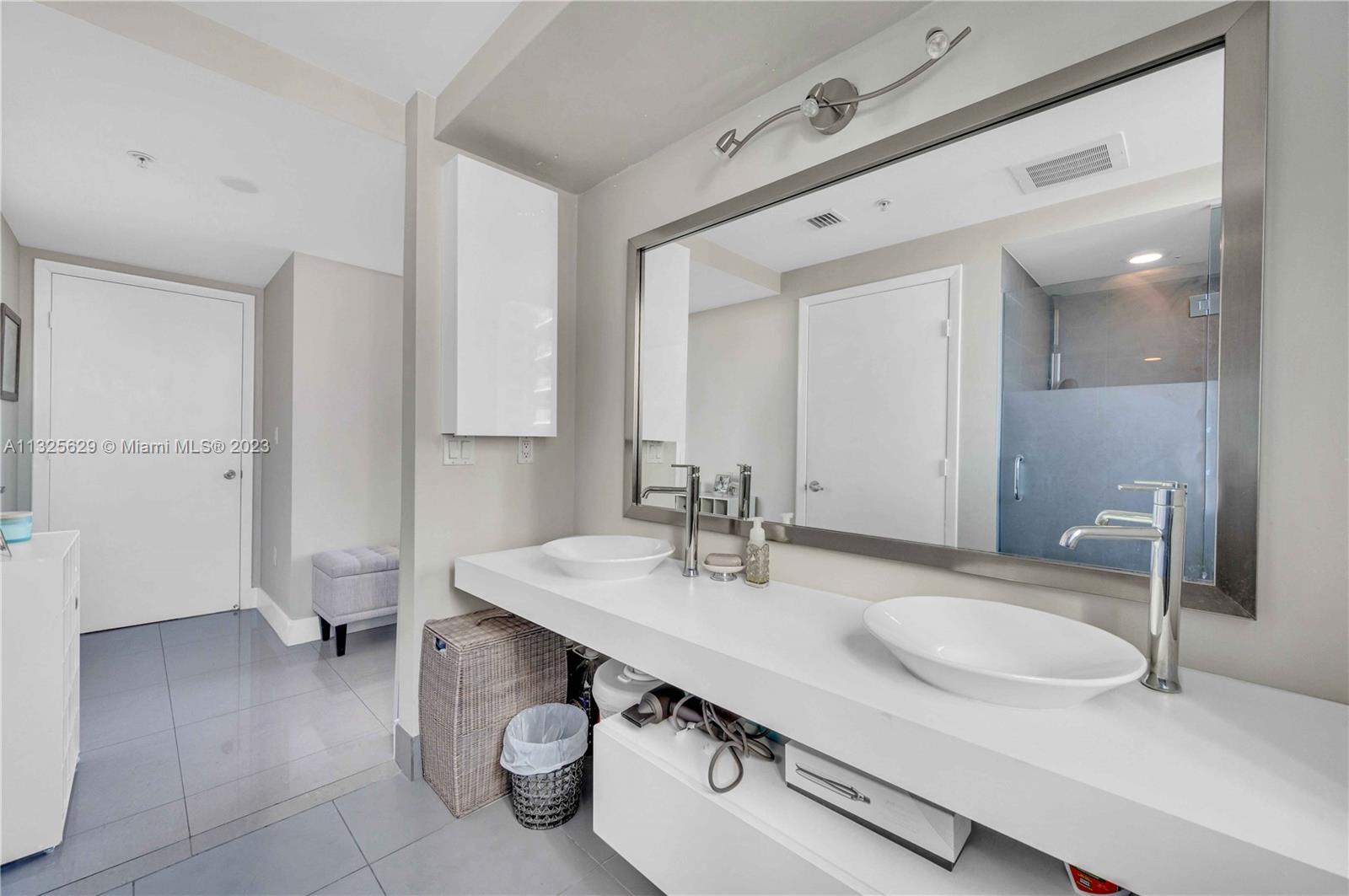 92 Southwest 3rd Street, Unit 1605 Miami, FL 33130 - Photo 30 of 37 a bathroom with a sink double vanity and a toilet