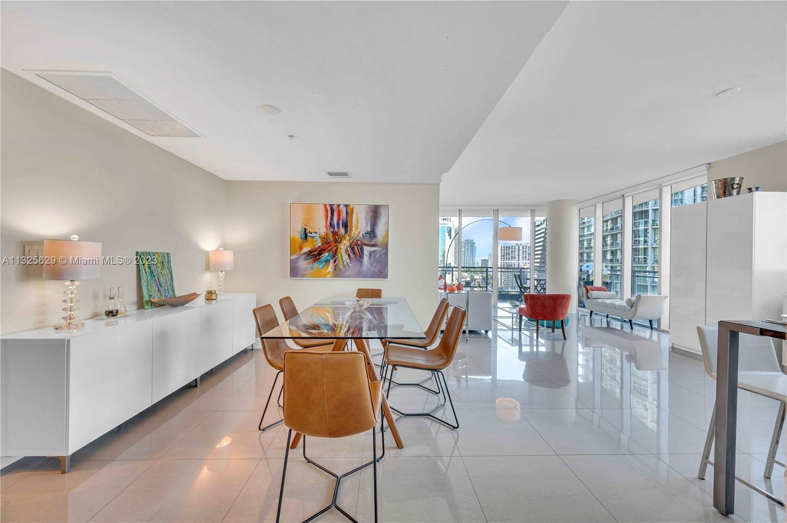 92 Southwest 3rd Street, Unit 1605 Miami, FL 33130 - Photo 10 of 37 a dining room with furniture and wooden floor