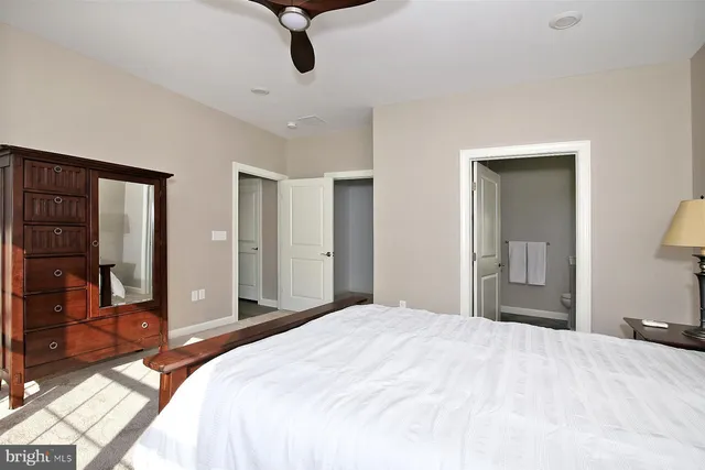 a bedroom with a bed and a dresser