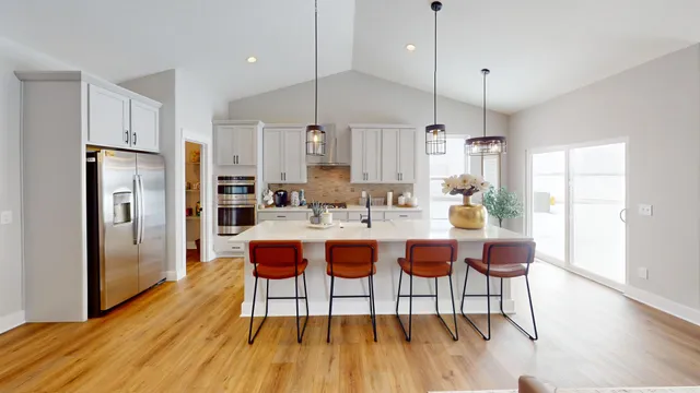 a kitchen with stainless steel appliances a refrigerator sink and cabinets