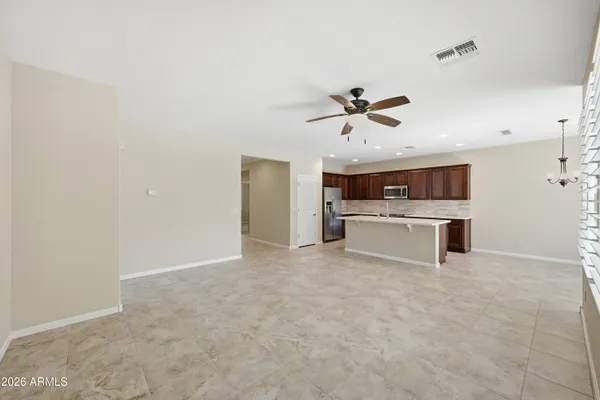 a view of kitchen with cabinets and refrigerator