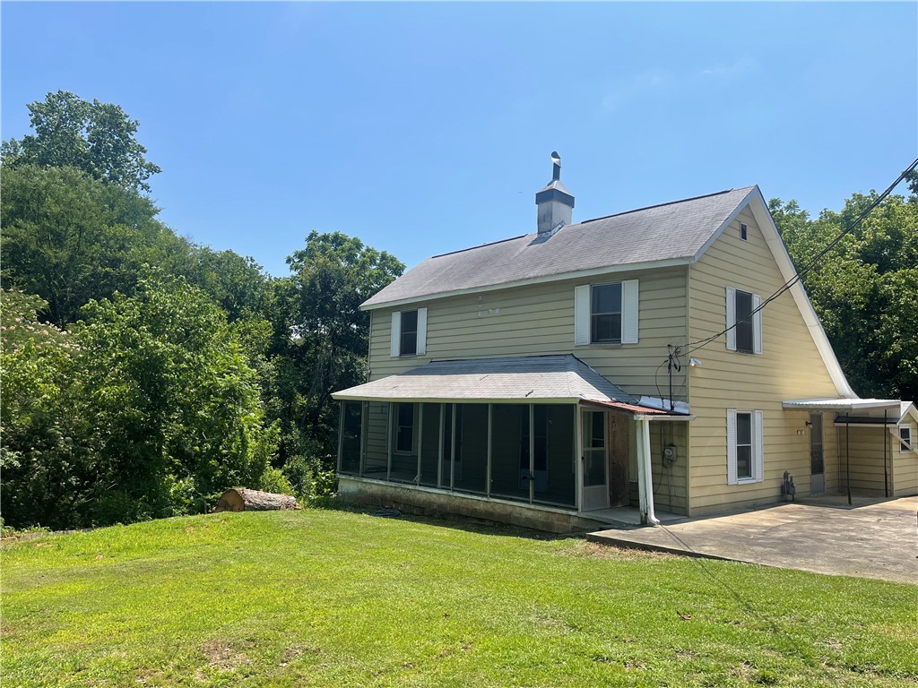 171 River Ridge Road Seneca, SC 29672 - Photo 21 of 22 A charming residence featuring classic siding and a screened-in porch, nestled against a backdrop of mature trees.