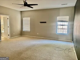 an empty room with windows and closet