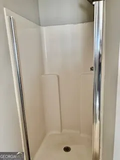 a bathroom with a toilet and a rug