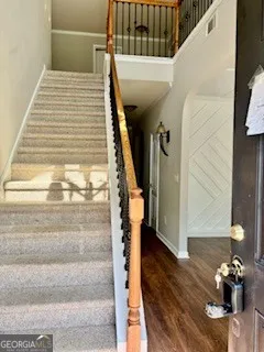 a view of entryway and hall with wooden floor