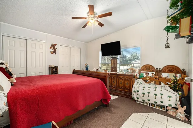 a bedroom with two beds and a chandelier