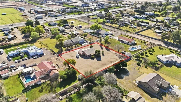 an aerial view of a house with a yard and pool