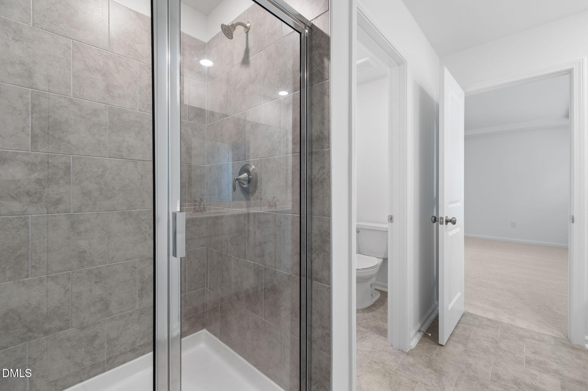 421 Deep Oak Drive, Unit SAWYER Rolesville, NC 27571 - Photo 11 of 16 a bathroom with a glass shower door