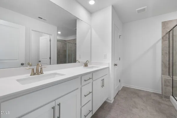 a bathroom with a double vanity sink mirror and double