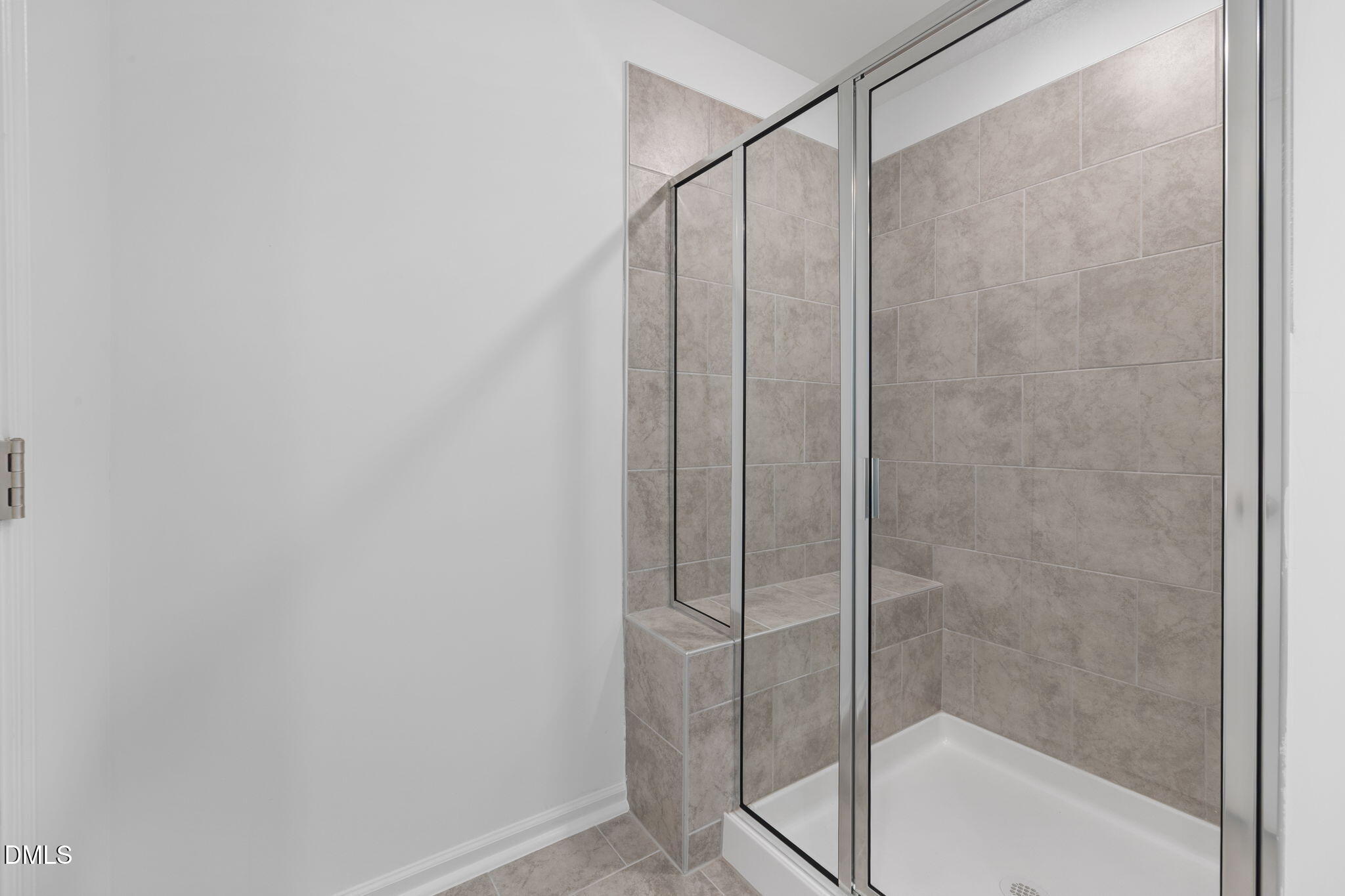 421 Deep Oak Drive, Unit SAWYER Rolesville, NC 27571 - Photo 10 of 16 a bathroom with a glass shower door