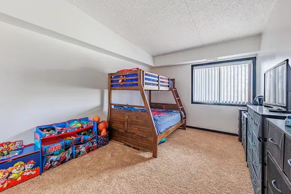 a bedroom with stairs and a bed