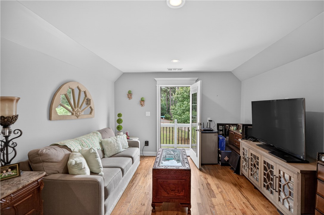 206 James Hare Road Anderson, SC 29626 - Photo 27 of 37 Hardwood floors and a balcony access create a versatile bonus room or living area.