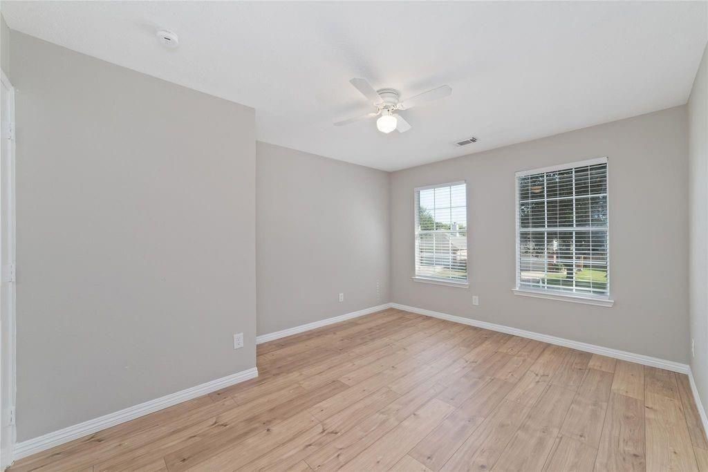 4007 Starbridge Pointe Lane Katy, TX 77449 - Photo 13 of 30 an empty room with wooden floor and windows