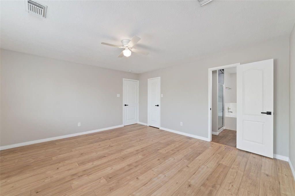 4007 Starbridge Pointe Lane Katy, TX 77449 - Photo 18 of 30 a view of empty room with wooden floor and ceiling fan