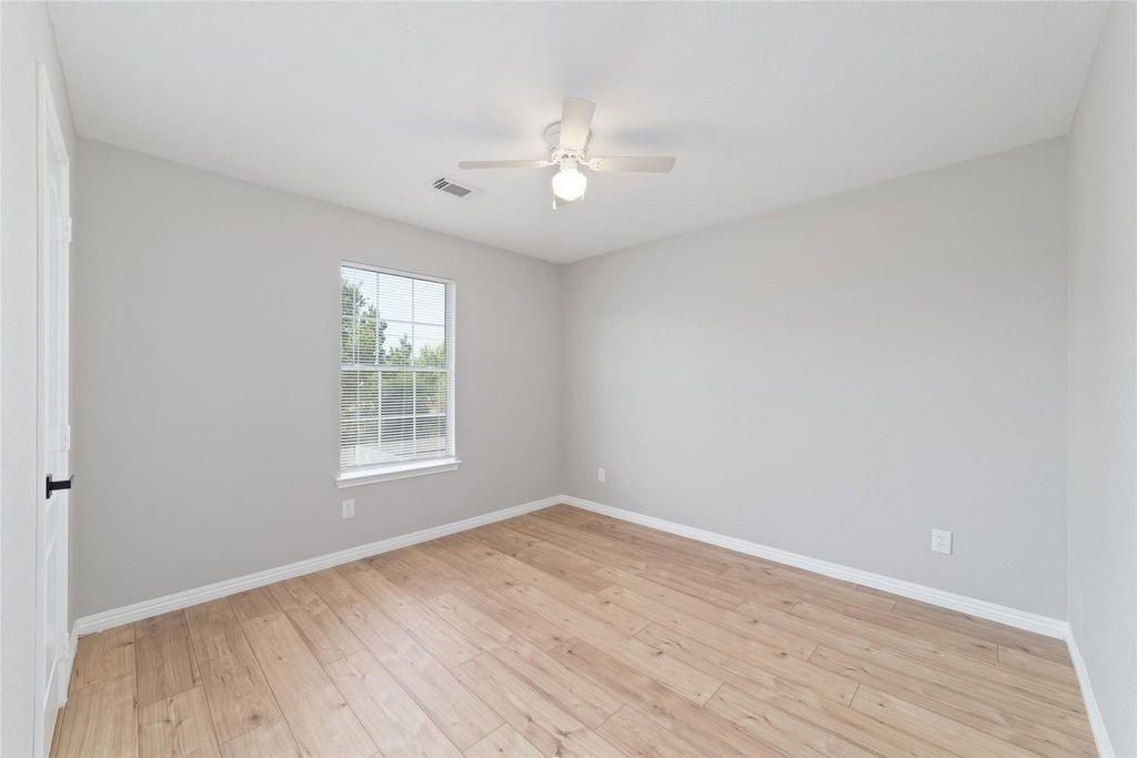 4007 Starbridge Pointe Lane Katy, TX 77449 - Photo 22 of 30 wooden floor in an empty room with a window