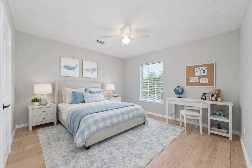 4007 Starbridge Pointe Lane Katy, TX 77449 - Photo 24 of 30 a bedroom with a bed and a table in it