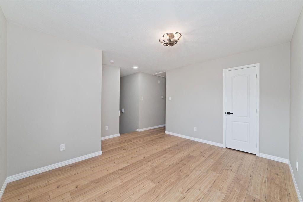 4007 Starbridge Pointe Lane Katy, TX 77449 - Photo 26 of 30 a view of an empty room with wooden floor