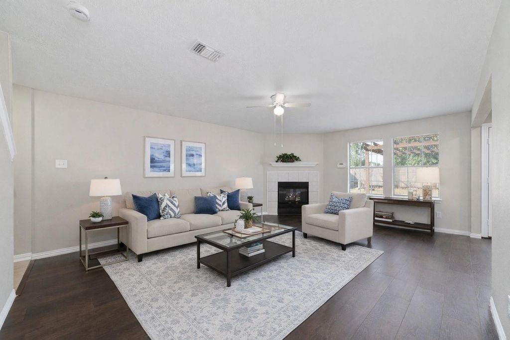 4007 Starbridge Pointe Lane Katy, TX 77449 - Photo 5 of 30 a living room with furniture and a fireplace