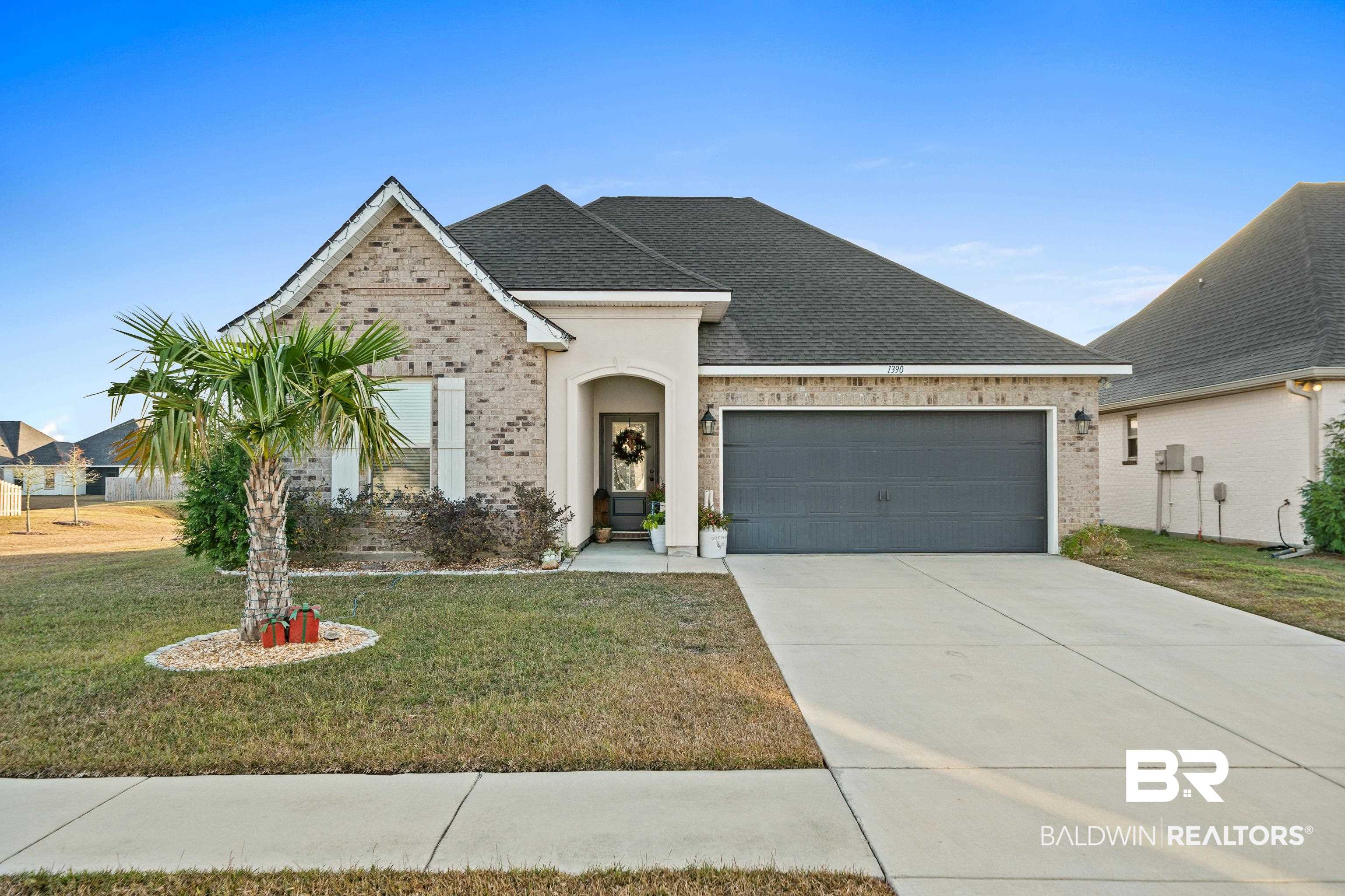 1390 Aldon Street Foley, AL 36535 - Photo 2 of 31 View of front of home with brick siding, a front yard, a shingled roof, and a garage