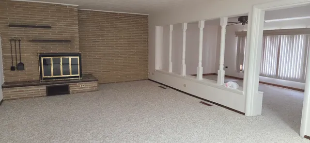 a view of a livingroom with entryway and stairs