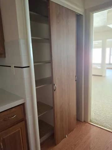 a view of walk in closet with empty racks