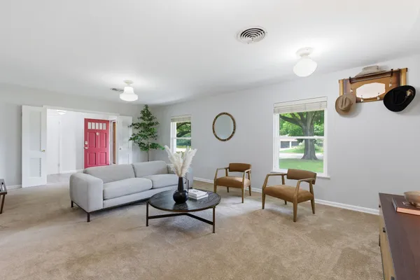 a living room with furniture and a large window