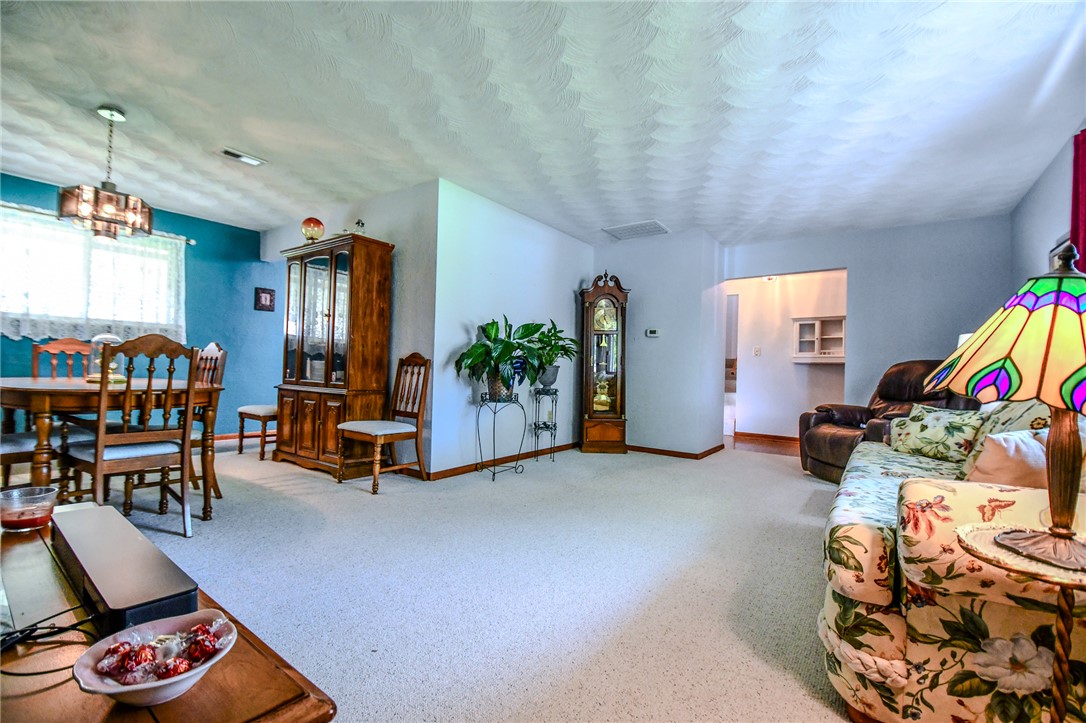 10833 Kendig Road Medway, OH 45341 - Photo 12 of 46 This inviting interior features a dedicated dining area seamlessly flowing into a spacious living room.